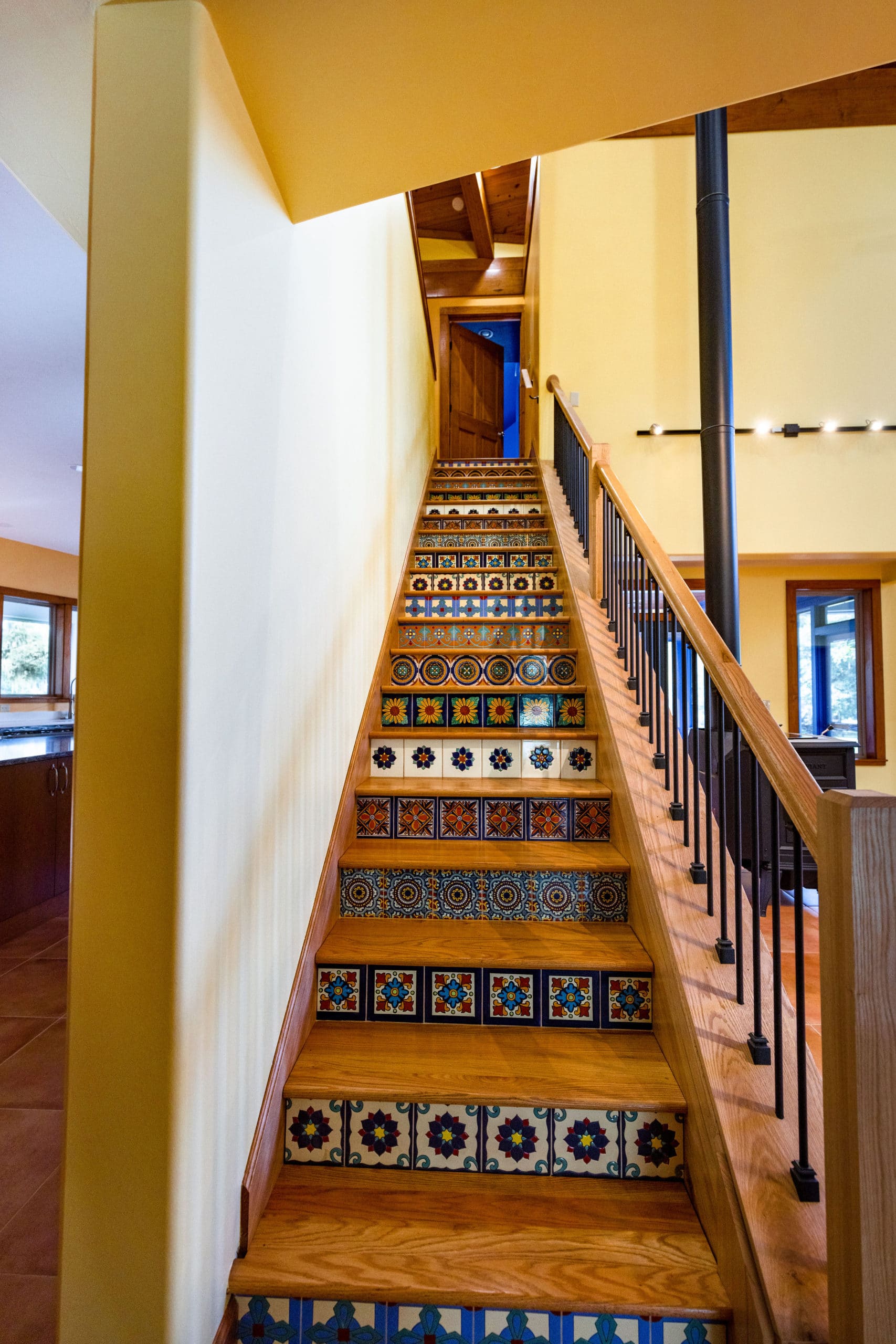 Interior Home Remodel - Beautiful wood staircase complete with decorative tiles.