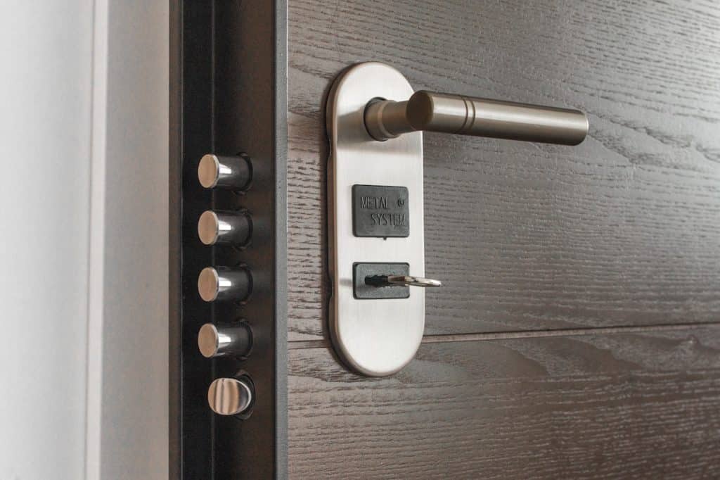 Heavy door ajar showing 4 sliding bolts for keeping a home secure
