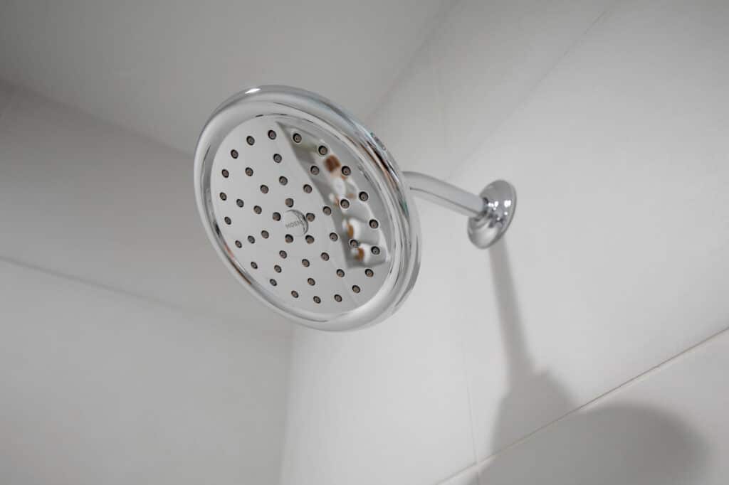 Chrome showerhead fitted in bathroom