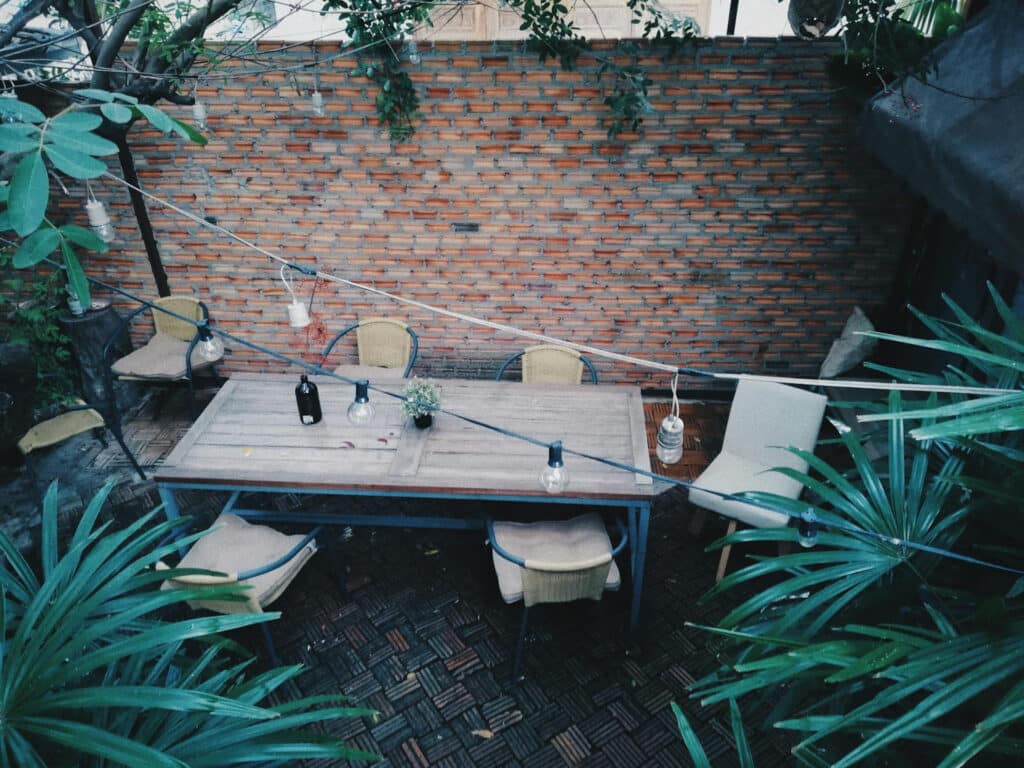 Backyard table seen from above under overhanging atmospheric lighting 